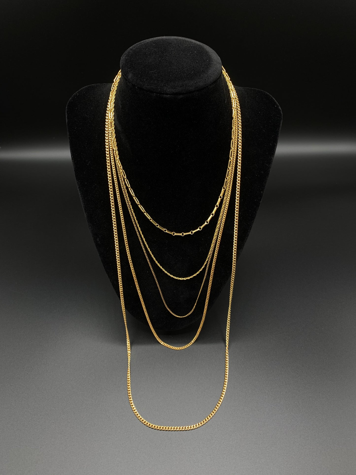 18 Inch Rope Chain layered with 15 Inch Anchor Chain, 21 Inch Curb Link Chain, 24 Inch Curb Link Chain, and 30 Inch Curb Link Chain